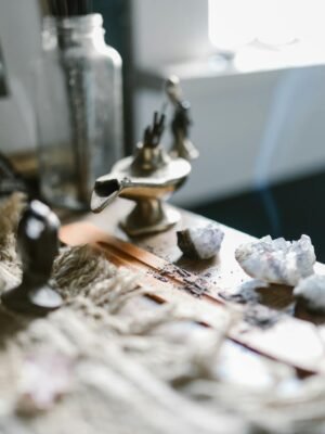 An enchanting arrangement featuring crystals and incense on a wooden surface, evoking tranquility and spirituality.